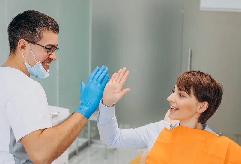 Happy patient pointing to smile